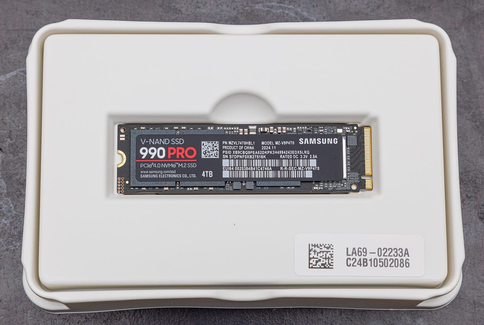 A Samsung 990 PRO M.2 NVMe SSD resting in its retail tray.